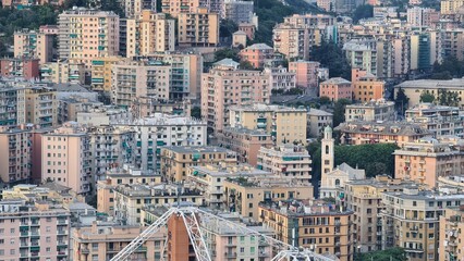 Wall Mural - Genoa, Italy - May 6, 2023: Top view of the city of Genoa at sunset from the mountains. Aerial view of Genoa and Sampdoria soccer teams stadium in Genoa Marassi in Italy.