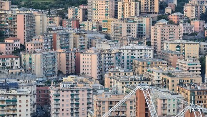 Wall Mural - Genoa, Italy - May 6, 2023: Top view of the city of Genoa at sunset from the mountains. Aerial view of Genoa and Sampdoria soccer teams stadium in Genoa Marassi in Italy.