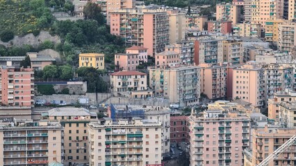 Wall Mural - Genoa, Italy - May 6, 2023: Top view of the city of Genoa at sunset from the mountains. Aerial view of Genoa and Sampdoria soccer teams stadium in Genoa Marassi in Italy.