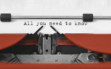 Text All you need to know typed on retro typewriter