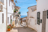 Fototapeta Uliczki - Altea old town with narrow streets and whitewashed houses. Architecture in small picturesque village of Altea near Mediterranean sea in Alicante province, Valencian Community, Spain