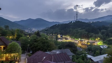 Wall Mural - Time lapse night view of Dilijan city in Armenia with mountains and moving clouds in background