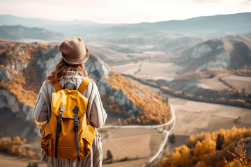 Wall Mural - A woman with a backpack looks out over a valley. Generative AI.