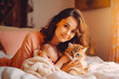 © VisualProduction - Charming brunette woman playing with her baby and cat in living room. Motherhood and family concept. Generative AI