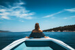 © KEA - View from behind woman relaxing on a luxury boat. Generative AI