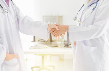 two doctor shaking hand together in hospital, hand in hand, be in unity and teamwork, they feeling happy in work time