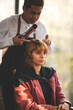 © chokniti - Asian Hairdresser giving treatment and barber occupation service, Professional hairstylist combing and using scissors cut woman's hair to young beautiful customer girl in beauty salon