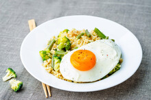 Stir Fried Millet With Broccoli, Green Beans And Fried Egg. The Toning. Selective Focus