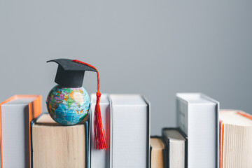 Wall Mural - Graduation cap with Earth globe. Concept of global business study, abroad educational, Back to School. Education in Global world, Study abroad business in universities in worldwide. language study