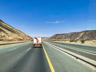 cargo truck going on the highway through the desert