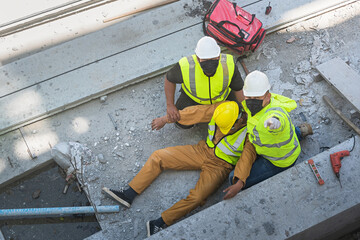 Wall Mural - A construction worker had an accident at work, fell from a height, seriously injured. First aid to save the lives of construction site workers in an accident.