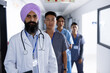 © Wavebreak Media - Portrait of diverse male and female doctors standing in corridor at hospital