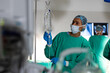 © Wavebreak Media - Biracial female surgeon inspecting drip bag in operating theatre at hospital