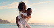 © Sean A E/peopleimages.com - Black couple, piggyback on beach and travel with hug, love and freedom outdoor, sea view and mockup space. Nature, adventure and vacation, man and woman bonding, happiness and trust in relationship