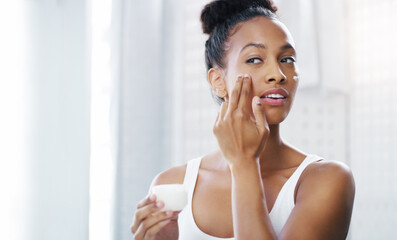 Poster - Woman, face and mirror with cream for beauty, moisturizer and cosmetic product with morning routine in bathroom. Female person apply lotion to skin, skincare and dermatology at home with mockup space