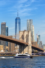 Wall Mural - New York City skyline of Manhattan with Brooklyn Bridge, World Trade Center skyscraper and ferry portrait format in the United States