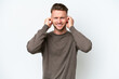 © luismolinero - Young blonde caucasian man isolated on white background frustrated and covering ears