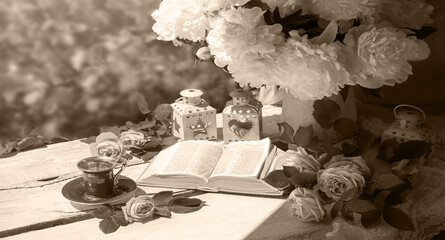 Wall Mural - Book and coffee near a bouquet of flowers