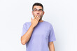 © luismolinero - Young caucasian man isolated on white background yawning and covering wide open mouth with hand