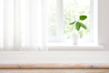 Wall Mural - wood table on blur window sill background for product montage