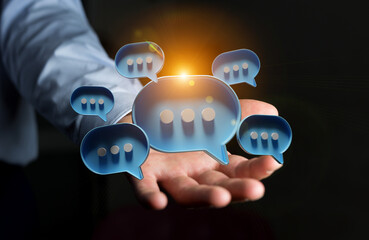 Wall Mural - Businessman in dark using digital speech bubbles talk icons. Minimal conversation or social media messages floating over user hand. 3D rendering
