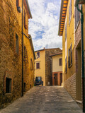Fototapeta Uliczki - An old three-wheeler on the cobbled streets of San Quirico d'Orcia
