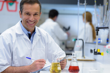 handsome teacher of chemistry working in laboratory