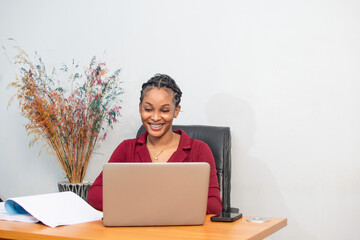 beautiful african female secretary working with her laptop