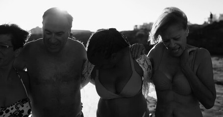 Canvas Print - Multiracial senior people hugging each other on the beach during sunrise time - Joyful elderly lifestyle concept, travel and summer vacation concept - Black and white editing