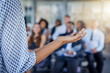 © Koegelenberg/peopleimages.com - Presentation, hand and a speaker coaching at a conference for training or workshop. Business, corporate and a woman manager speaking to a crowd at a seminar or convention for leadership or mentoring