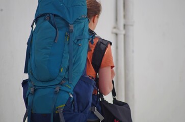  Woman with a huge blue tourist backpack on her back