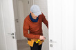 © Angelov - Cheerful locksmith installing a door lock on a new white door
