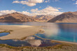 
Mountains and Pangong tso (Lake). It is huge lake in Ladakh, altitude 4,350 m (14,270 ft). It is 134 km (83 mi) long and extends from India to Tibet. Leh, Ladakh, Jammu and Kashmir, India