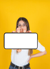 Smartphone mockup, portrait of young woman holding smartphone mockup. Caucasian girl showing  horizontal mobile phone with white blank close up empty screen. Blurred face, looking to camera. 