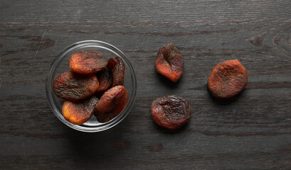 Wall Mural - Dried apricots on a wooden background