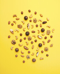 Wall Mural - Pattern of nuts mix on yellow background