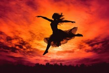 Fiery Passion: Captivating Silhouette Of A Dancer Embracing The Sunset Glow