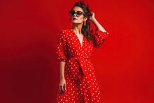 Stylish Indian Woman In Summer Fashion Trend Dotted Red Dress Posing On Red Generative Ai