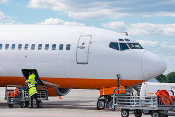 Airplane luggage loading at airfield