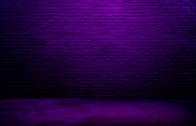 Dark Black Brick Wall Background, Rough Concrete, Plastered Concrete Floor, With Neon Purple Glowing Lights From Above. Lighting Effect Violet And Blue On Empty Brick Wall Background For Design.