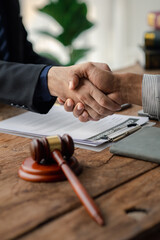 Lawyers shake hands with clients who come to testify in the case of embezzlement from business partners who jointly invest in the business. The concept of hiring a lawyer for legal proceedings.