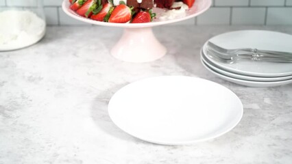 Sticker - Step by step. Slicing red velvet bundt cake with cream cheese frosting garnished with fresh strawberries.