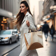 young woman with mock-up shopping bag walking in city