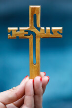 Woman Holding A Wooden Christian Cross With The Name Of Jesus, Symbol Of Religion And Faith, Vietnam