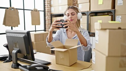 Sticker - Young blonde woman ecommerce business worker packing professional camera using computer and headphones at office