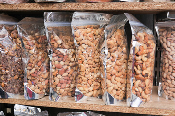 Canvas Print - close up of many mixed nuts in plastic packet 
