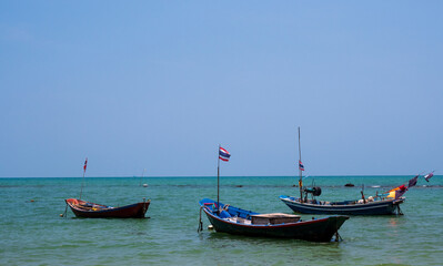 landscape look view point Small fishing boat wooden parked coast sea beach. after fishing of fishermen in small village It small local fishery. Blue sky, white clouds clear weather