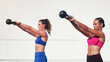 © Emil Lime/peopleimages.com - Woman, personal trainer and kettlebell in weightlifting for fitness, exercise or workout together outdoors. Women lifting kettle bells for exercising, strength or training body in health and wellness