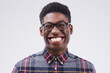 Portrait, mockup and black man with a smile, funny and confident against a grey studio background. Face, male person and model with facial expression, humor and geek laughing, comic and happiness