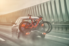 The Car Carries Bikes. A Vehicle Traveling Along A Motorway With Several Bikes Held On The Rear Using A Bike Carrier Mount. A Vehicle With Bicycles.